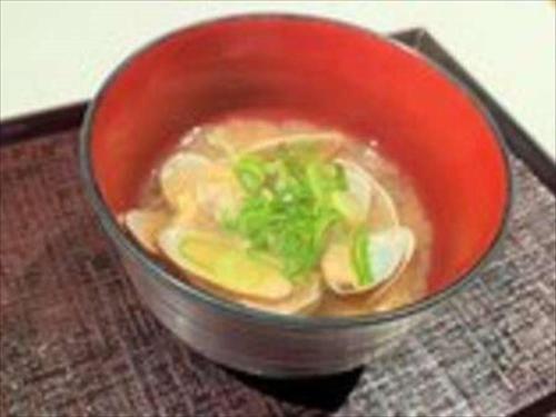 a red bowl of soup on a table at Dormy Inn Hiroshima in Hiroshima