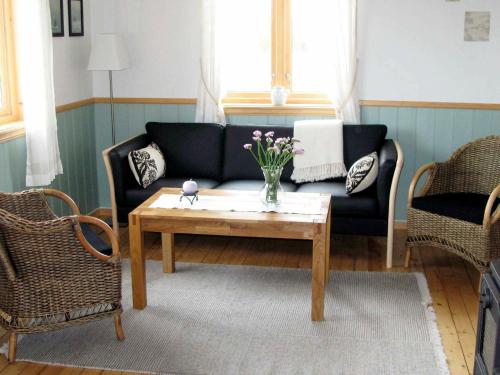a living room with a couch and a coffee table at 6 person holiday home in ALSV G in Gisløy