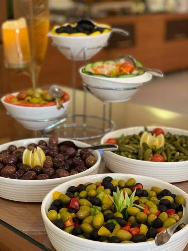a table topped with bowls of different types of fruit at Sama Inn Hotel in Riyadh