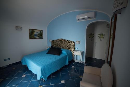 a bedroom with a bed in a blue room at San Giacomo Relais in Furore