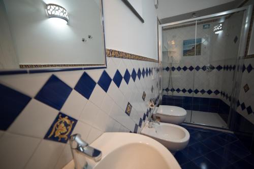 a bathroom with two toilets and a sink and a mirror at San Giacomo Relais in Furore