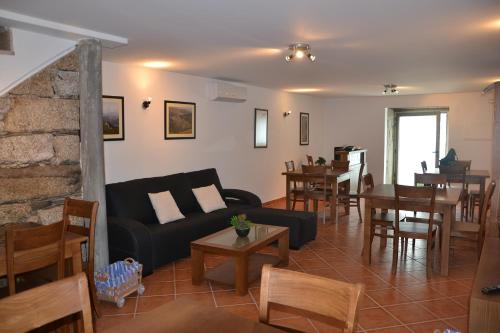 a living room with a couch and chairs and a table at Recantos da Montanha in Candal