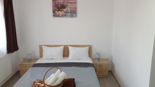 a small bedroom with a bed with two night stands at Casa Corina in Turda