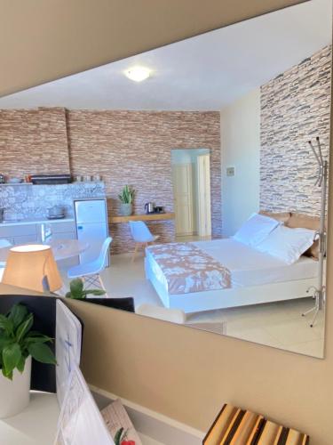 a bedroom with a bed and a living room at Nautica Hotel Apartments in Stavromenos