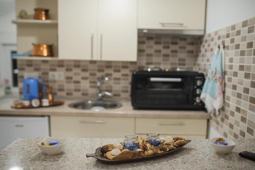 a plate of food on a counter in a kitchen at Studio Apartments KIM - Dilberovic in Mostar