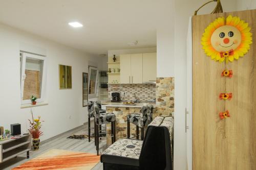 a kitchen with a door with a sunflower on it at Studio Apartments KIM - Dilberovic in Mostar