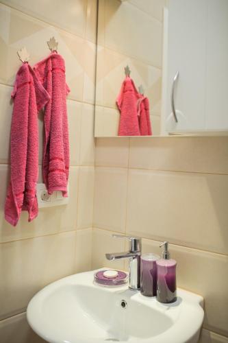 a bathroom with a sink and pink towels at Studio Apartments KIM - Dilberovic in Mostar