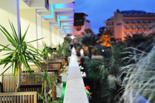 a walkway in a city with plants and buildings at Camyuva Beach Hotel in Kemer