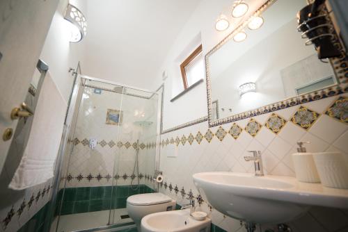 a bathroom with a sink and a toilet at San Giacomo Relais in Furore