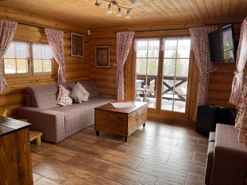 a living room with a couch and a table at Chata Wuja Toma in Szczyrk