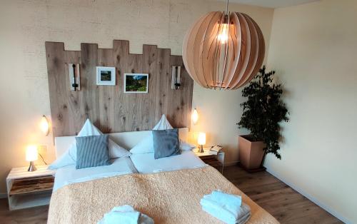 a bedroom with a large bed with a wooden headboard at Hotel Restaurant Tomahawk in Baiersbronn