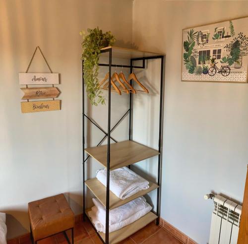 a shelf with shoes on it in a room at Casa Lagar de Arume in Ponteareas
