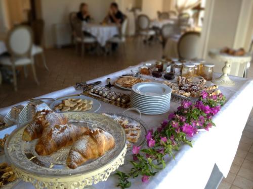 a table with a buffet of pastries and croissants at Hotel Villa Calandrino in Sciacca