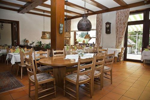 a dining room with a wooden table and chairs at Hotel & Restaurant Krone in Waldbronn