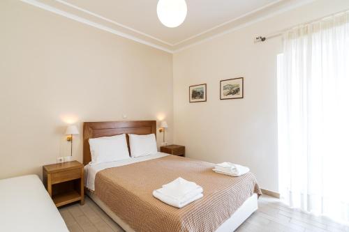 a bedroom with a bed with two towels on it at Alisahni studios in Nikiana