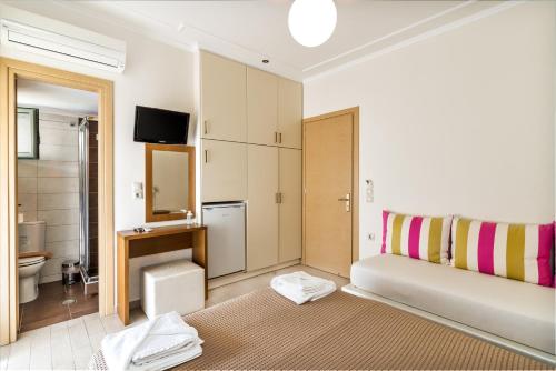 a bathroom with a bed and a sink and a toilet at Alisahni studios in Nikiana