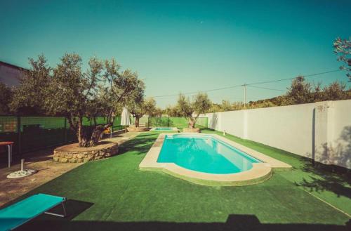 a swimming pool in the middle of a yard at Posada Peñarubia in Peñarrubia