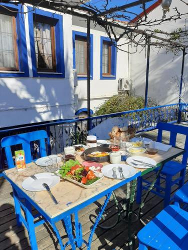 a blue table with food on it on a balcony at Sığacık Antik Otel in Siğacık