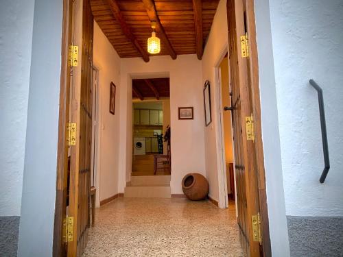 a hallway with two open doors to a room at Casa Rural Sierra Tórtola 1 in Hinojales