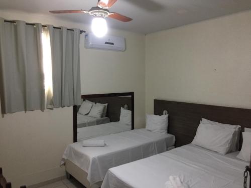 Łóżko lub łóżka w pokoju w obiekcie Novo Hotel Barro Preto