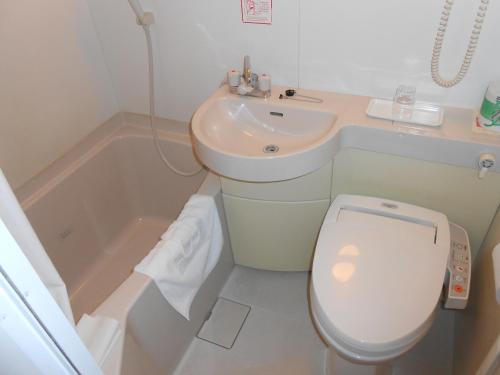 a bathroom with a toilet and a sink at R&B Hotel Kumagaya Ekimae in Kumagaya