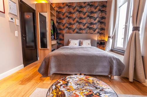 a bedroom with a bed and a rug on the floor at Luxury Suites Boutique by Rikas Hotels in Antwerp