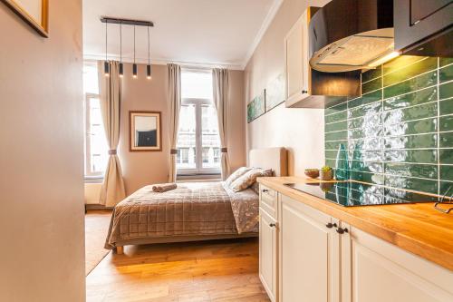 a small kitchen with a bed in a room at Luxury Suites Boutique by Rikas Hotels in Antwerp