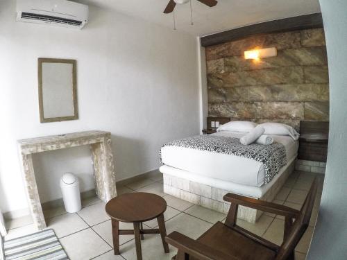 a bedroom with a bed and a fireplace at La Casa de las Lunas in Chichén-Itzá