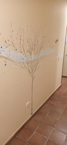 a wall mural of a tree with confetti at HOSTAL LA GRANJA ** in Palazuelos de Eresma