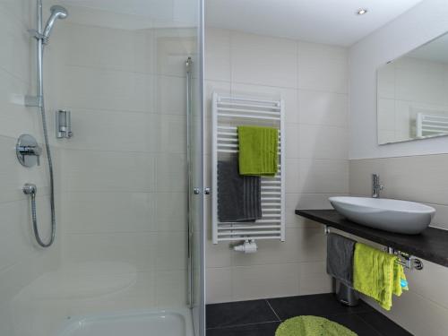 a white bathroom with a sink and a shower at Alpenapart Frank in Längenfeld