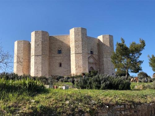 a building with three towers on top of a field at Bed & Breakfast De Nittis in Barletta