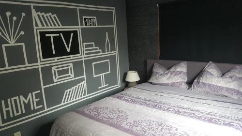 a bedroom with a bed and a wall with whiteitures at Chalet nur für Urlauber Familien in Putten an der Veluwe Krachtighuizerkern 22 & free Bikes in Putten