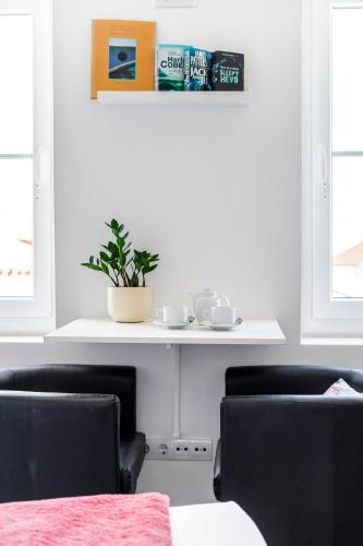 a dining room with two chairs and a table at Castle Inn Lisbon Apartments in Lisbon