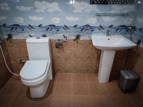 a bathroom with a toilet and a sink at Blooming Rose Ella in Ella