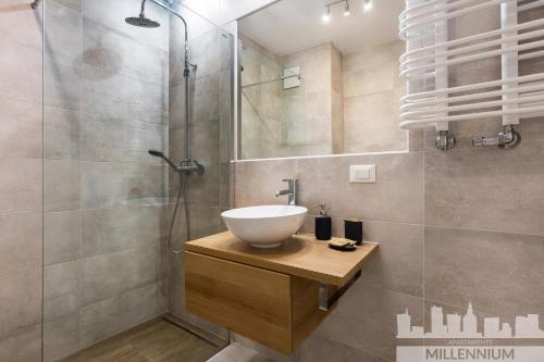 a bathroom with a sink and a shower at JM Millennium Port in Warsaw