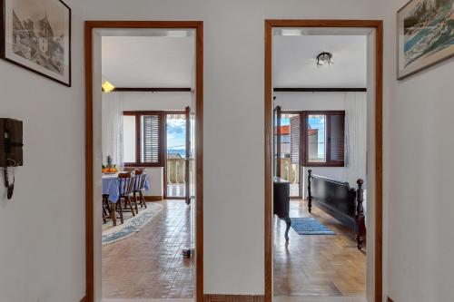 a hallway with two doors leading to a dining room at Apartments Tihomir Mušac in Omiš
