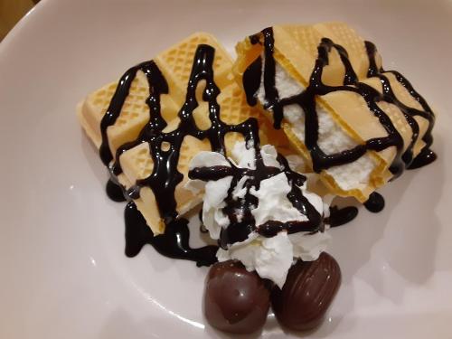 two waffles and ice cream on a white plate at RESORT HOTEL Ka (Adult Only) in Chosei
