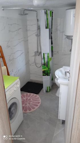 a bathroom with a washing machine and a sink at Holiday home Marija in Vrlika