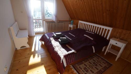 a bedroom with a large bed in a wooden room at Zawoja Dom Czatoża in Zawoja