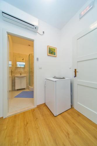 an empty room with a door open to a bathroom at Guest House Katica in Zaton