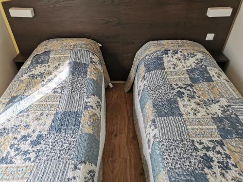 two beds sitting next to each other in a room at FASTHOTEL PARIS OUEST BOUAFLE in Bouafle