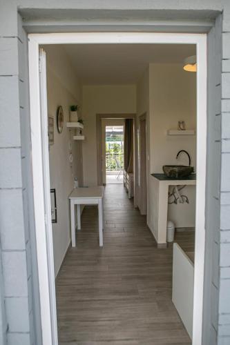 a hallway leading to a kitchen with a table at Aelia Sea View Studios in Afitos