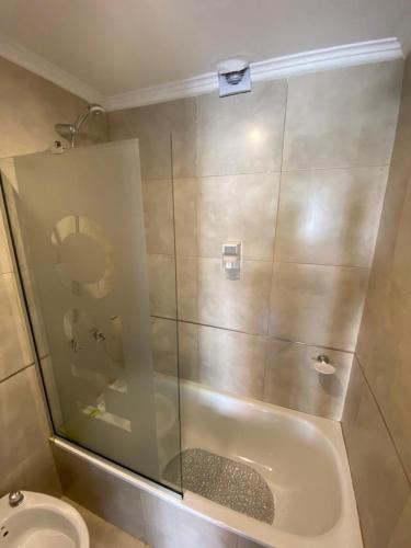 a bathroom with a shower and a toilet and a tub at Vittorio 55 in La Plata