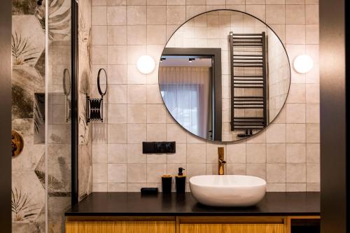 a bathroom with a sink and a mirror at Białka Residence Ski - EUFORIA in Białka Tatrzanska
