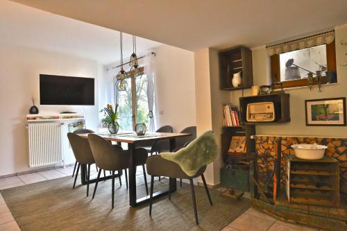 a dining room with a table and chairs at Bellevue in Malente