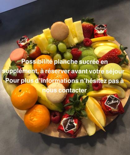 a plate of fruits and vegetables on a table at Studio Au numéro 10, proche zoo de Beauval et sortie d autoroute in Villefranche