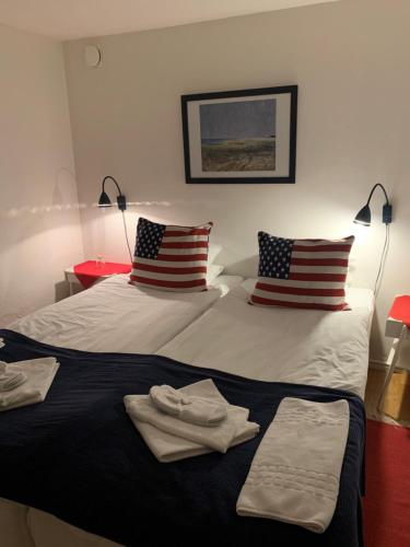 two beds in a room with towels on them at Hotell Kaprifol in Hunnebostrand