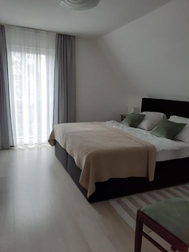a bedroom with a large bed and a large window at Kunst und Meer in Varel