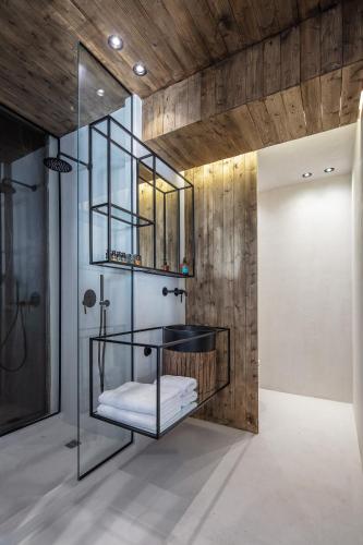 a bathroom with a glass shower and a sink at TinosVillages in Tinos