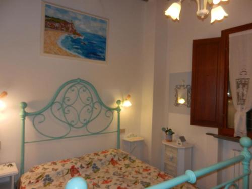 a bedroom with a bed with a green headboard at PietraMilia in Terricciola